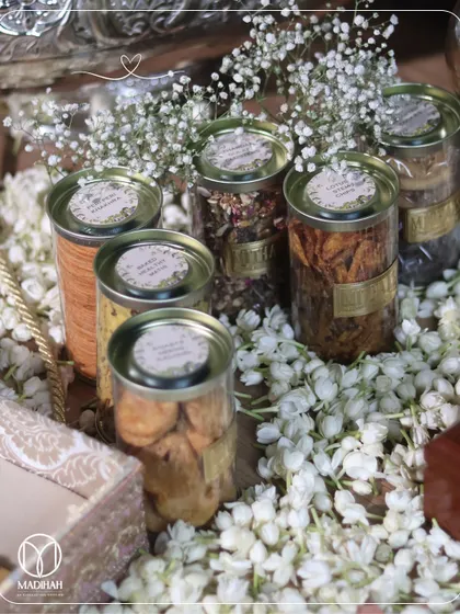 A beautiful, rustic arrangement of gourmet treats in clear-top tins, nestled amongst a bed of baby's breath. This Bhaji box is a feast for the eyes as well as the palate.