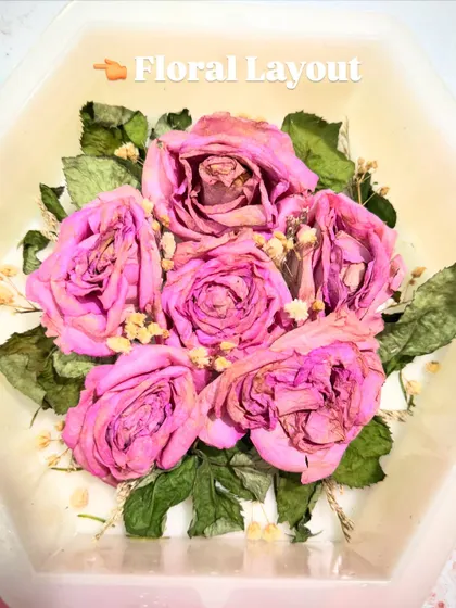 The floral layout for the hexagon block, with the dried pink roses carefully arranged before being set in resin.