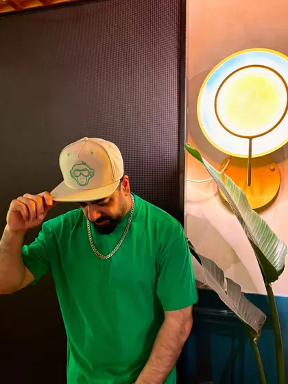 A candid moment, adjusting my cap before dropping the next classic track for the VIBE CHECK crowd.