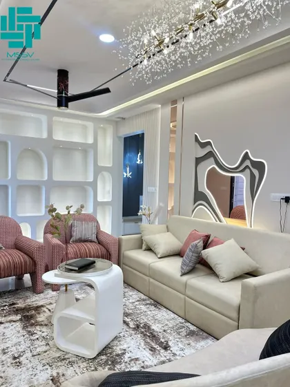 Another view of the living room, highlighting the abstract LED-backlit mirror, which serves as a unique piece of wall art and adds a modern, artistic touch to the space.