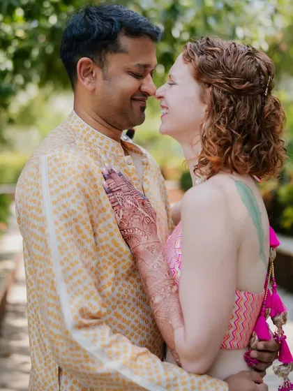 This close-up captures the joy of Rachael and Viraj's welcome event. You can see the details of her pink blouse and his yellow bandhani kurta, a perfect blend of their personalities.