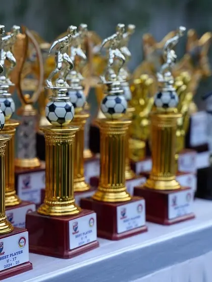 A closer look at the Best Player and Golden Boot trophies, symbols of excellence and dedication.