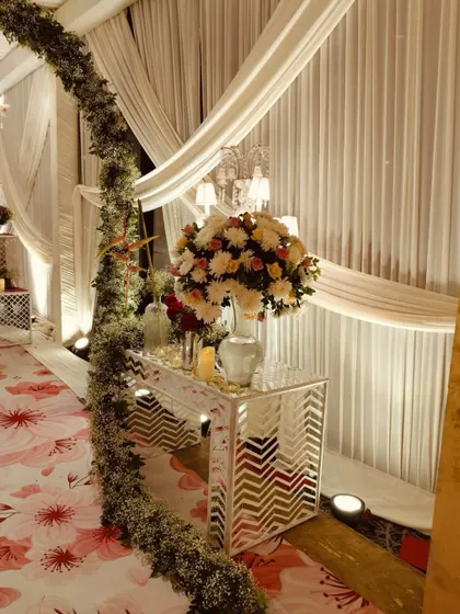 A floral wonderland walkway, with a lush arch of baby's breath and a vibrant printed carpet, creating a dreamy and romantic path.