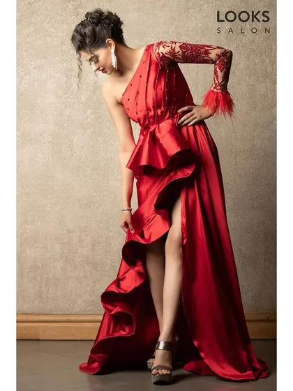 This full-length shot displays how our makeup and hair styling complete a glamorous evening outfit. The makeup is designed to be striking enough to balance the bold, ruffled red gown.