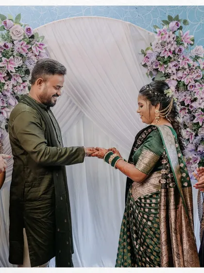 The couple holding hands after the ring exchange. This simple, happy moment is a beautiful symbol of their new commitment.