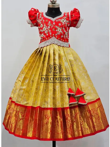 A mannequin view of the yellow and red pattu lehenga. The intricate silver and gold embroidery on the red blouse makes it a truly special piece.