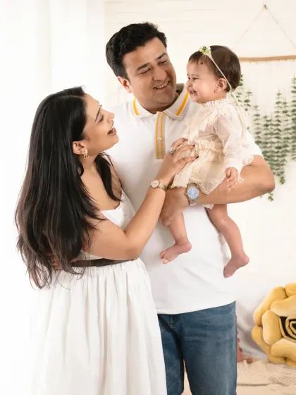 A playful and interactive family photo, filled with laughter and genuine smiles.