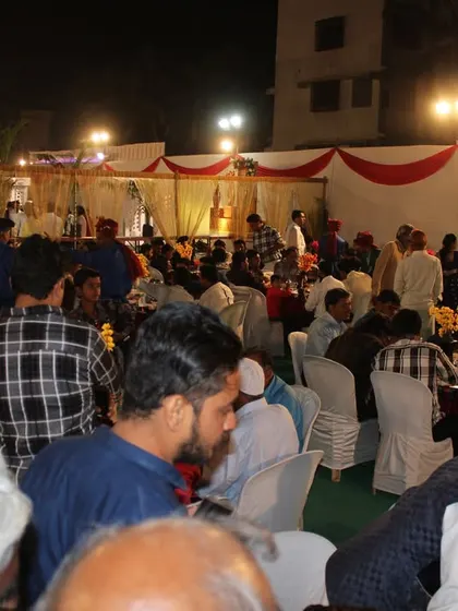 A wide shot of guests enjoying the wedding feast, highlighting the lively and celebratory atmosphere we help create.