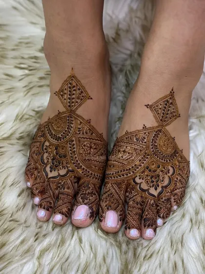 A unique and modern foot mehendi design that creates a bold statement with its geometric and floral patterns.