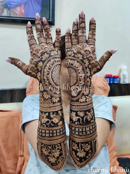 A stunning full-arm design with a large central mandala. The elephant and lotus bands on the arm complete this regal look.