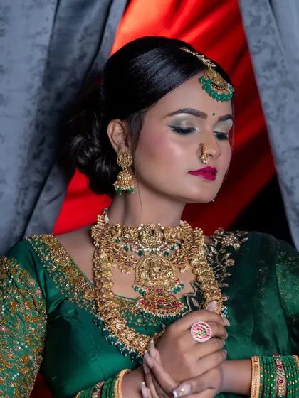 Another close-up focusing on the makeup and the intricate details of the choker and maang tikka.