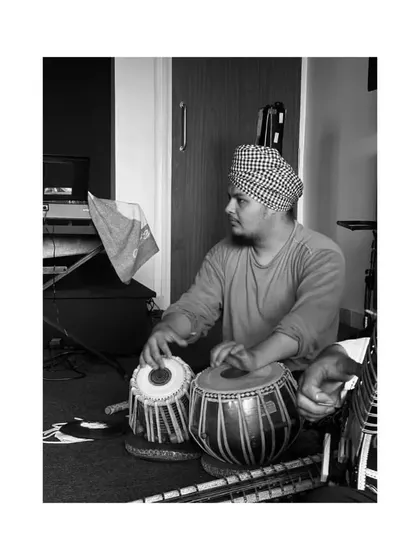 A candid black and white photo from a practice session. This shows a moment of quiet focus and dedication to the art form.
