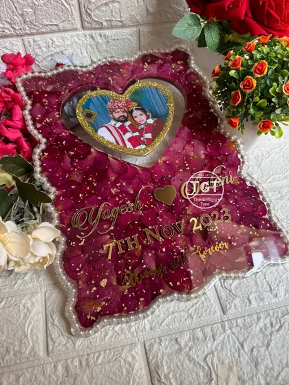 Another perspective of the heart frame, highlighting the depth created by the layers of petals and the hanging photo.