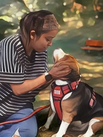 A touching, illustrated moment of a pet parent comforting her beagle in a park-like setting.