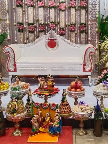 A complete ceremonial platter setup with a variety of decorated items. I ensure every element, from the fruit platters to the doll arrangements, contributes to a grand and festive atmosphere.