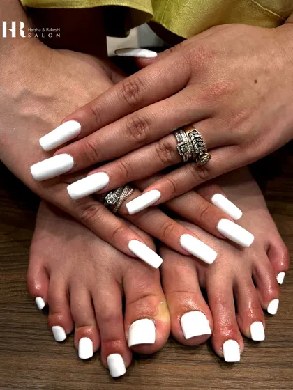 Clean, crisp, and perfectly coordinated. This matching manicure and pedicure in a solid, opaque white is a timeless look that exudes confidence and style.