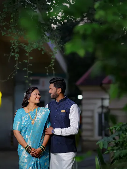 A beautiful outdoor portrait where the couple shares a happy, knowing glance. The natural setting adds a fresh and relaxed feel to their engagement photos.
