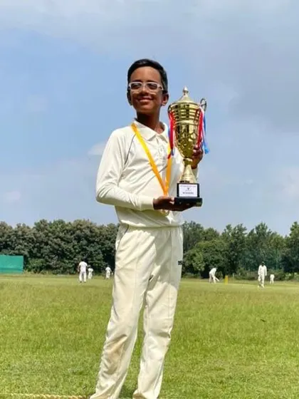 A young champion holding his trophy high. This player was a key part of our U12 team's victory, showcasing his talent on the field.