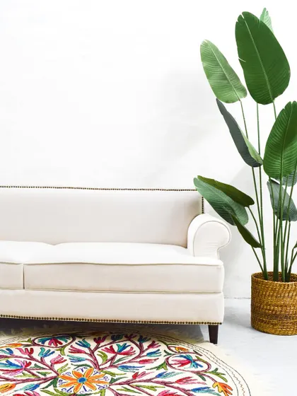 A full view of the custom-made ivory sofa, showcasing its simple yet sophisticated silhouette that can be adapted to various interior styles.
