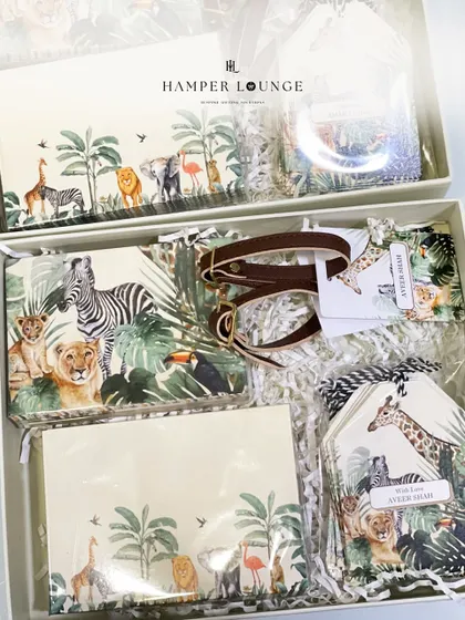 A look inside the safari-themed stationery set I designed as a return gift. It includes a personalized journal, notecards, and luggage tags, all featuring a beautiful jungle animal print.