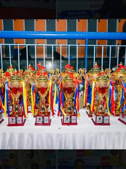 A table laden with trophies, ready to be presented to the deserving winners of the tournament. Each one represents a significant achievement.