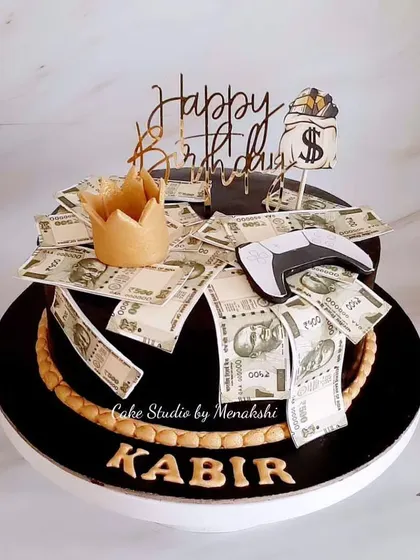 One of my most popular designs for men. This cake is all about luxury, with a crown, a gaming controller, and overflowing edible money.