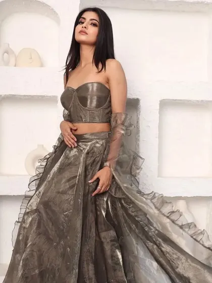 Another pose in the modern metallic lehenga, highlighting the structured corset top.