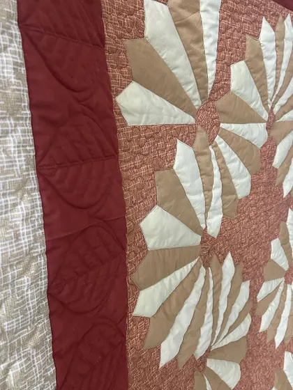 A close-up of the leaf-patterned quilting on the border.