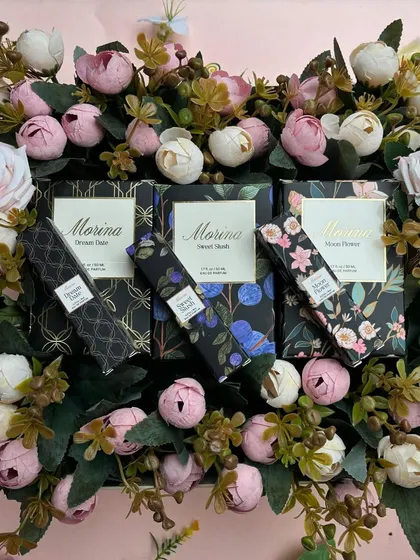 Morina Perfumes are a perfect addition to any festive hamper. This beautiful flat lay shows their elegant packaging surrounded by a bed of flowers.