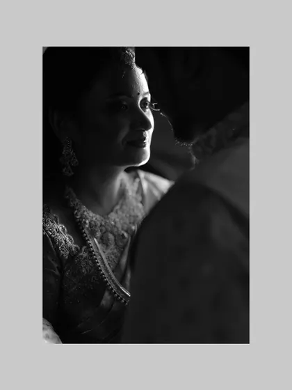 A close-up version of the beautifully lit black and white portrait, emphasizing the emotion in the bride's expression.