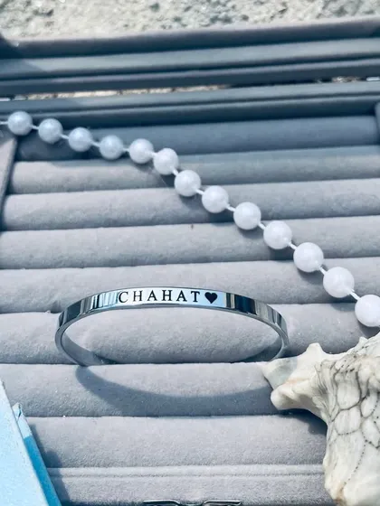 A silver 'Chahat' name Kada beautifully presented in a grey velvet jewelry box. This shows how every piece is packaged with care, ready for gifting.