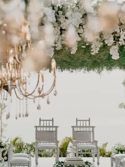 A detail shot of the mandap, with a canopy of baby's breath and white flowers creating a cloud-like effect.