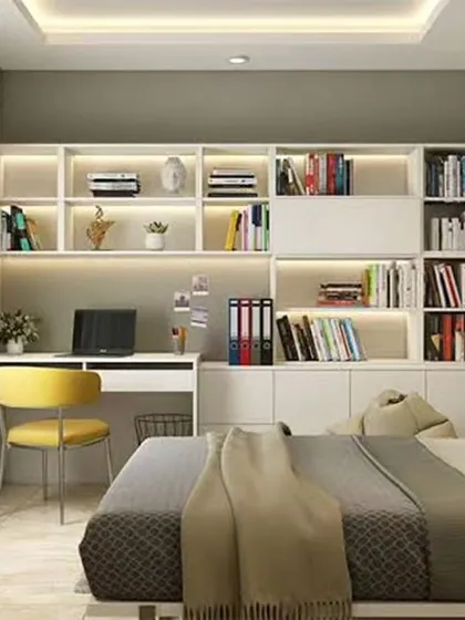 A bright and airy bedroom study area with white backlit bookshelves and a simple, functional desk.