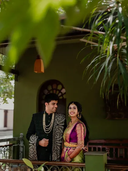 Framed by the rustic charm of The Tamarind Tree, this couple shares a look of love. We specialize in using unique angles and architectural elements to create memorable wedding portraits.
