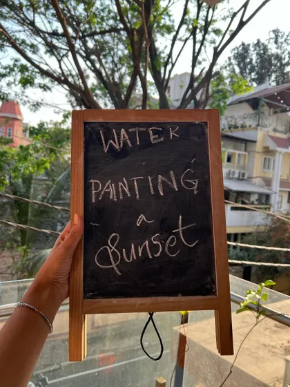 Our chalkboard sign announcing the day's activity: watercolor sunset painting. It's a simple way to build excitement for the session.