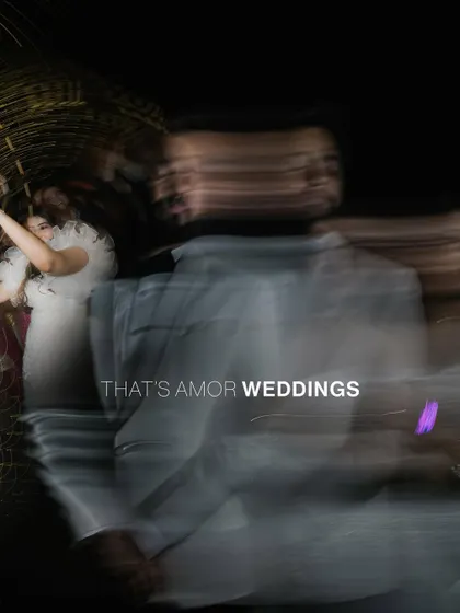 An abstract, long-exposure shot from a Christian wedding reception. The motion blur and light trails capture the energy and movement of the party.