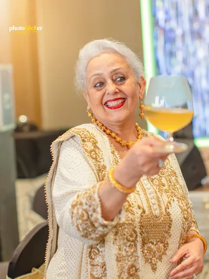 A joyful portrait of the matriarch raising a glass in a toast, her smile lighting up the room. We capture the spirit of the celebration in every shot.