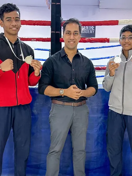 The proud brother-sister silver medalists with academy owner Devraj Das.