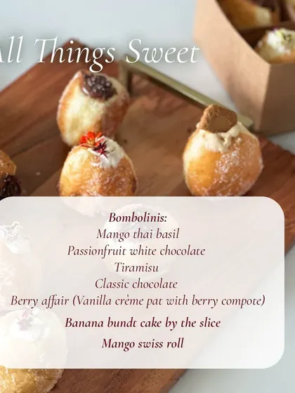 A menu board from a pop-up showing the sweet treats available, from various bombolinis to cake slices.