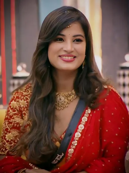 A smiling Anusha Rai, showcasing how a single statement necklace can elevate an entire look.