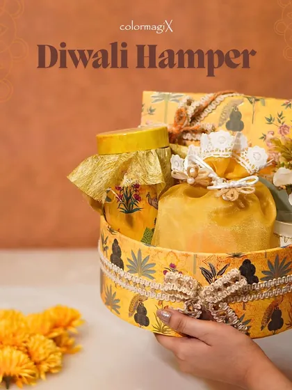 Our charming mini hampers are perfect for a personal touch. This yellow-themed round box is filled with festive treats and makes for a delightful and adorable Diwali gift.