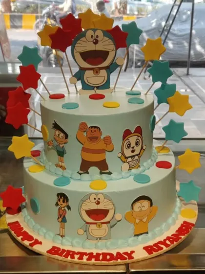 This two-tier Doraemon cake brings the whole gang together for a fun birthday celebration. It's decorated with edible images of Nobita, Shizuka, and friends, topped with colorful stars.