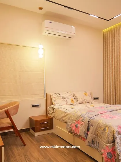 A cozy bedroom with a dedicated study nook. The combination of wood finishes and white furniture creates a bright and functional space, perfect for both rest and productivity.