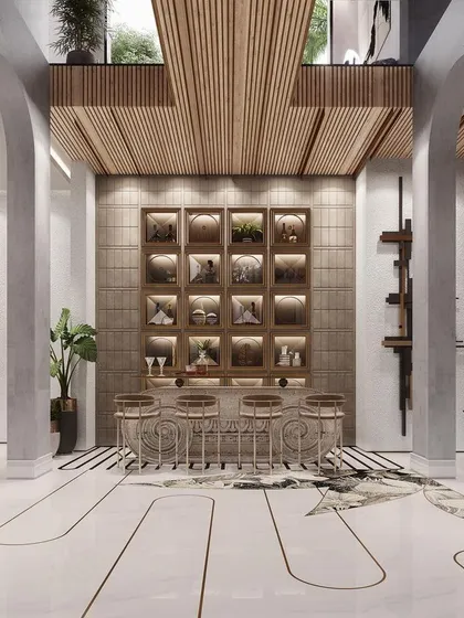 We designed this bar area with classical arches and intricate floor inlays to create a sophisticated entertainment zone. The custom-built bar with integrated shelving provides a stylish focal point for social gatherings.