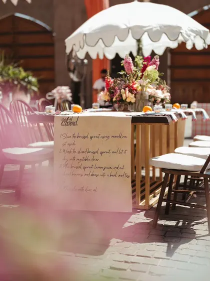 A unique table runner with a handwritten recipe, adding a deeply personal and creative touch to the tablescape at the Parisian Market Mehendi.