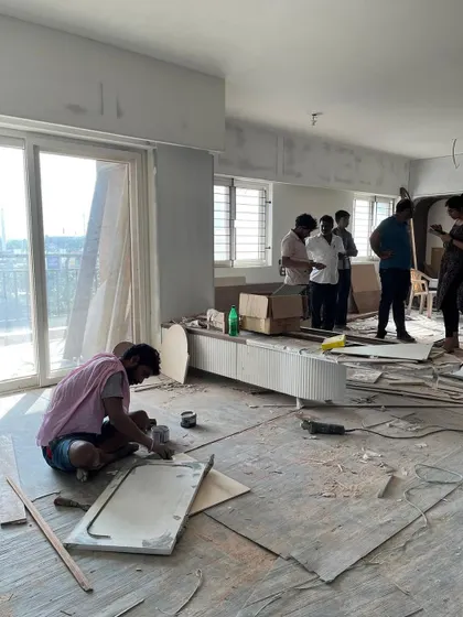 A single frame capturing our entire process. A carpenter works on the floor, while in the background, the project managers and architects discuss the next steps.