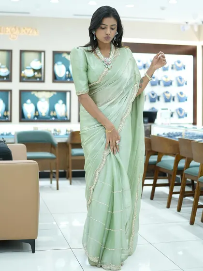 A full-length view of Sonu in the pastel green saree, showcasing its simple and classy design.