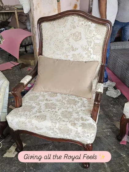 Giving all the royal feels, this classic accent chair features a beautifully carved dark wood frame and is upholstered in a traditional floral brocade fabric. It's a timeless piece that adds a touch of regal elegance to any space.