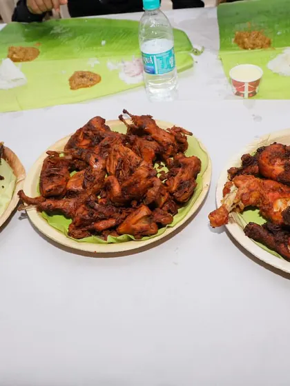 A variety of our non-veg starters served at an event. You can see fried fish, fried chicken pieces, and whole fried chicken, ready for the guests.