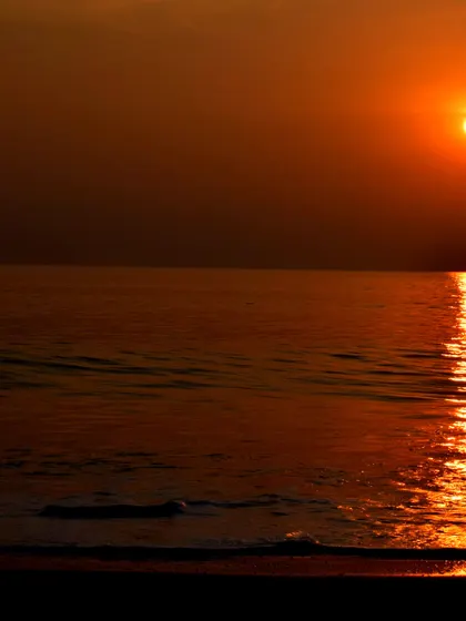 The sun dips below the horizon in Gokarna, painting the sky and sea in warm colors.